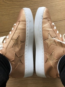 Photo of Hamilton style gold trainers with stars